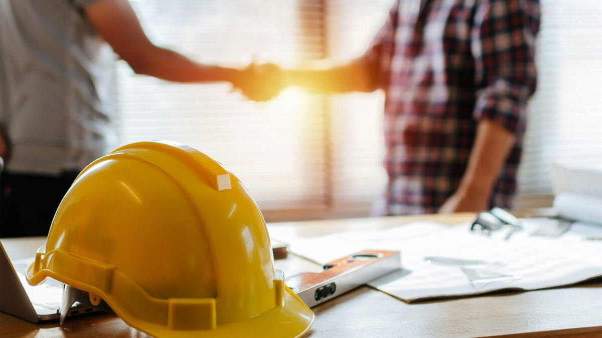 Yellow-Construction-Hat-Mens-Shaking-hands-behind